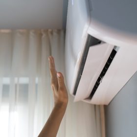 arm-reaches-for-air-conditioner-inside-home-2026-03-20-00-27-47-utc
